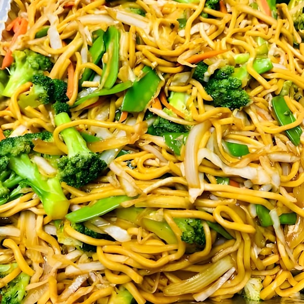 Close-up of Weng's Kitchen's lo mein noodles with broccoli, carrots, onions, and snow peas.